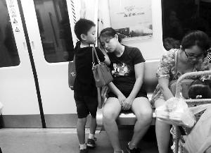 成都地铁“小暖男”走红：用手为妈妈垫着睡觉(图)